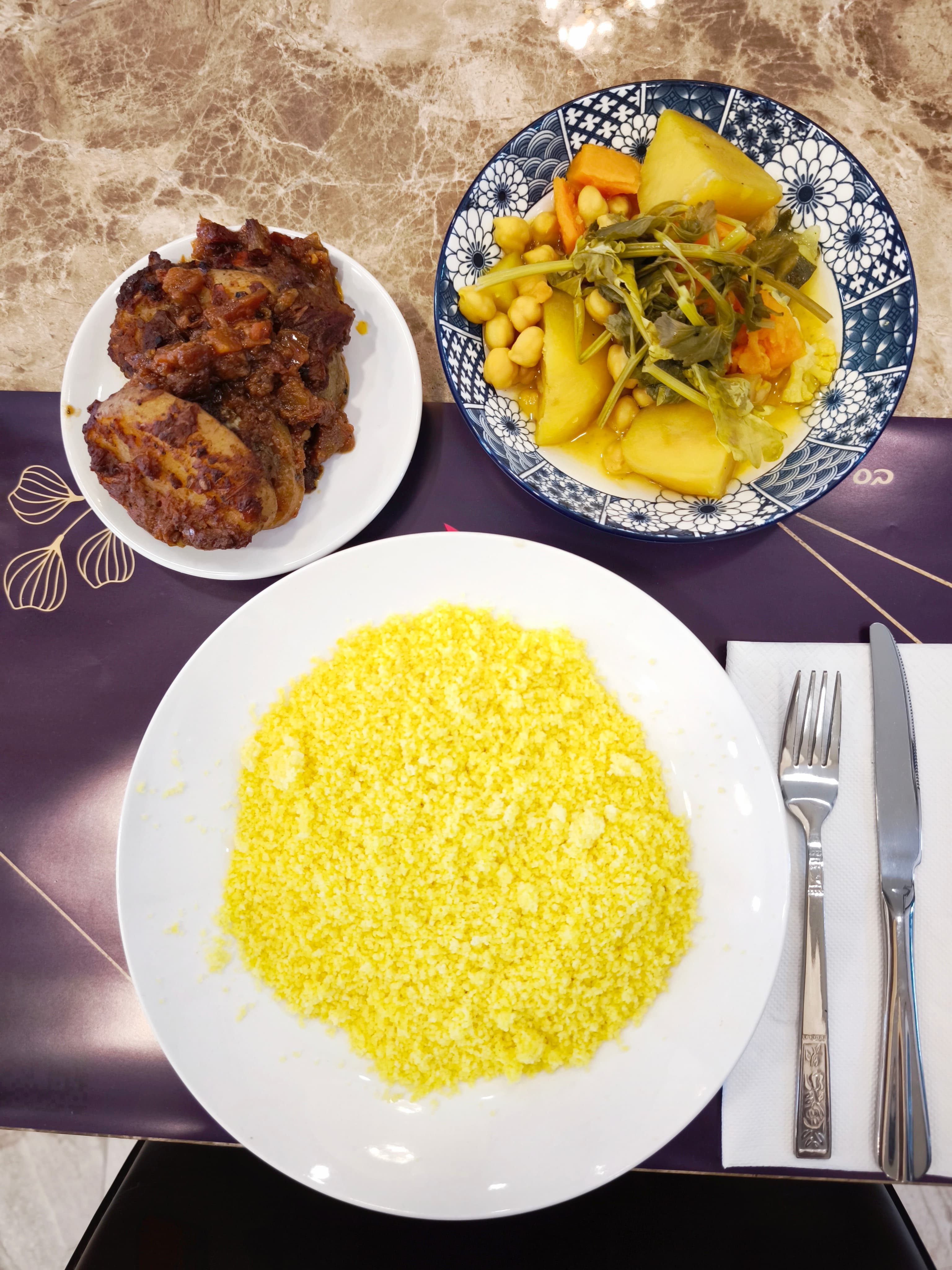 Yellow couscous, rich meat stew, and colorful vegetable stew with chickpeas and potatoes.